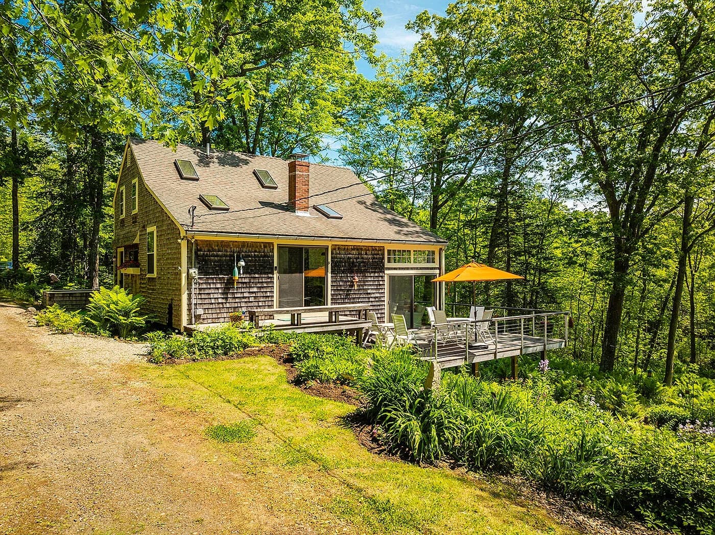 The cottage nestled in the coastal trees