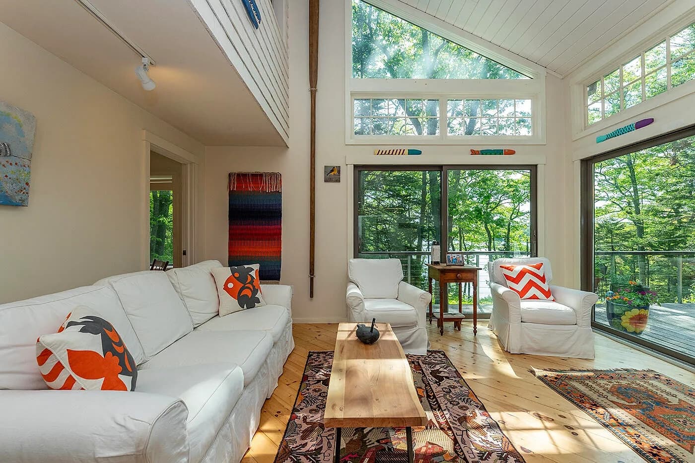 The open sunroom looking out to the deck and trees